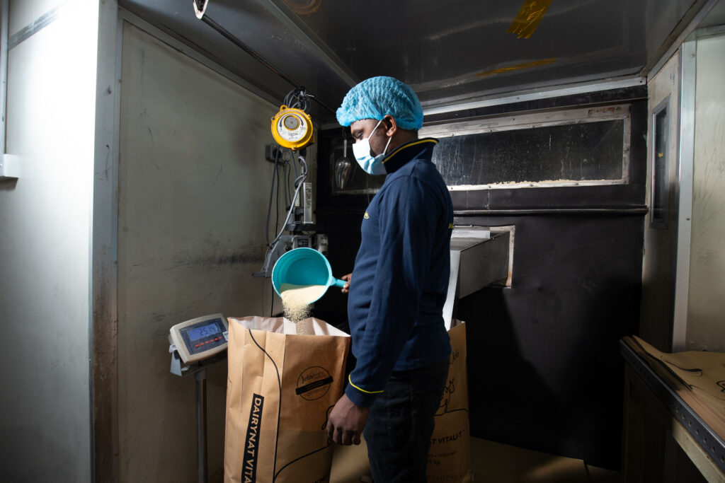 Ranama operator repackaging animal feed into a bag