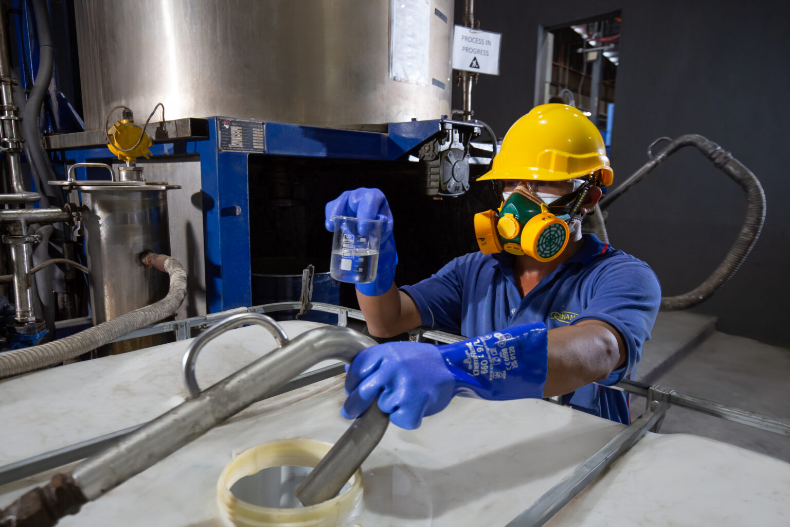 Ranama operator in protective equipment working with an industrial container