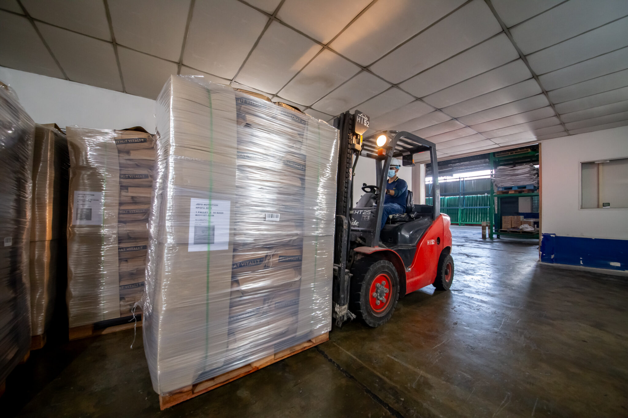 Forklift moving wrapped palletised materials within Ranama's industrial facility